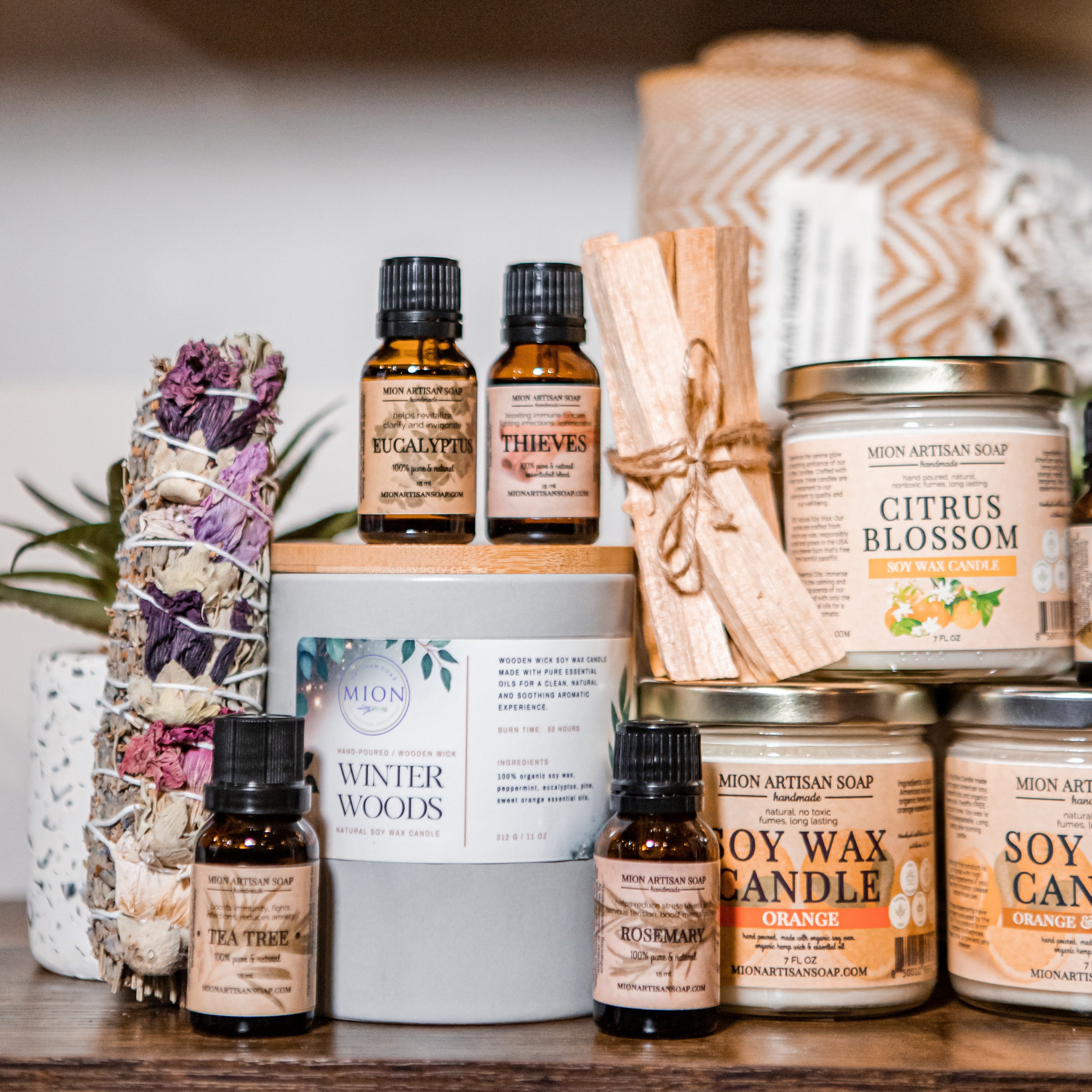 collection of candles and essential oils, smudge sticks and palo santo