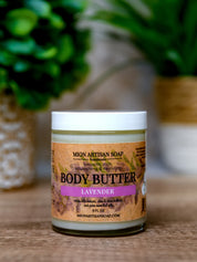 Jar of lavender body butter with a label on a wooden surface.