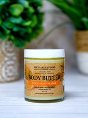 Jar of Mion Artisan Soap body butter with a plant in the background
