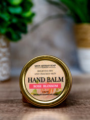 Hand balm container with 'Rose Blossom' label on a wooden surface